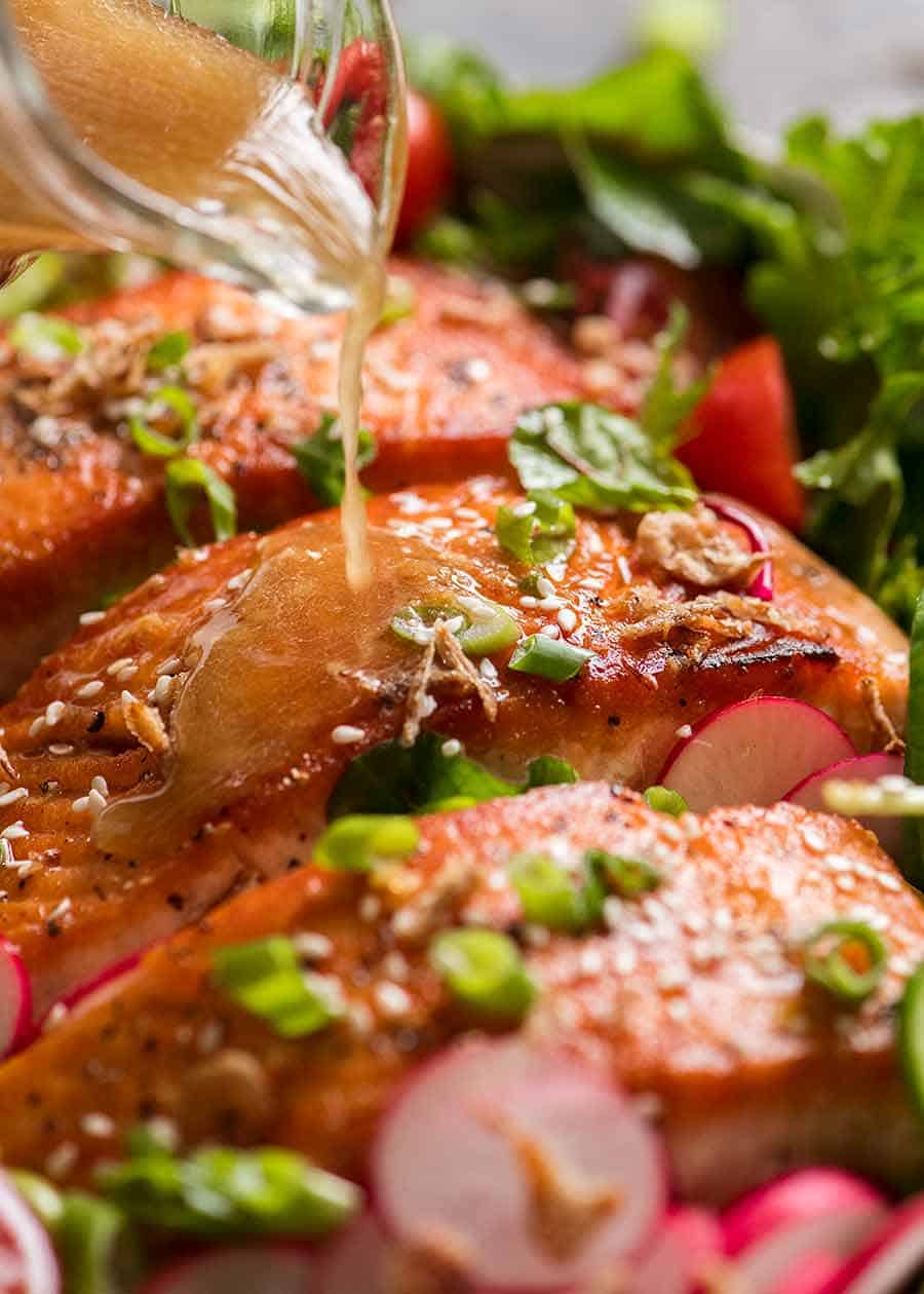 Asian Ginger Sesame Dressing being drizzled over Salmon Salad