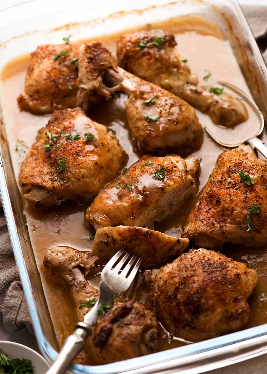 Pan of freshly baked chicken with gravy