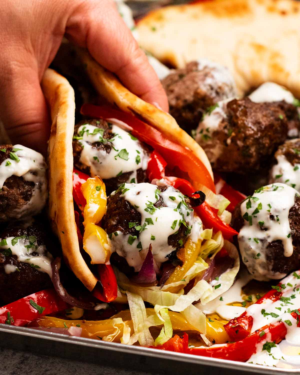 Pita bread stuffed with Baked lamb kofta meatballs and vegetables