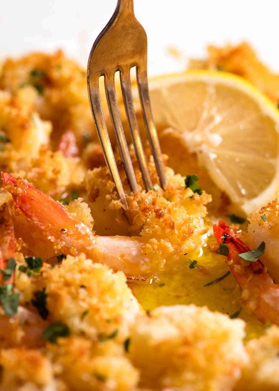 Fork picking up Baked Prawn in Lemon Garlic Butter Sauce