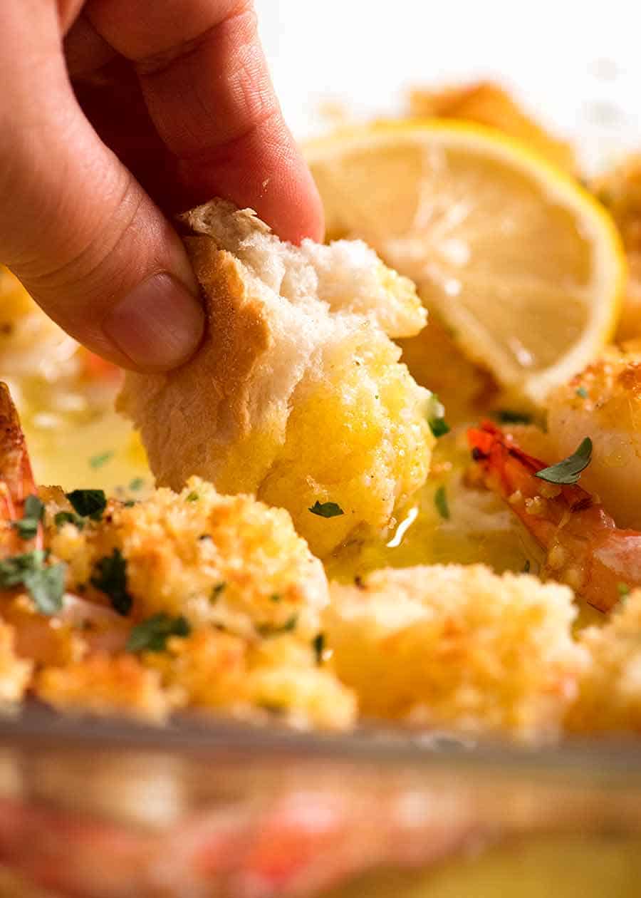 Dunking bread into Shrimp Lemon Garlic Butter Sauce