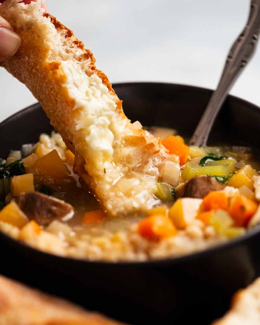 Dipping bread into Barley Soup