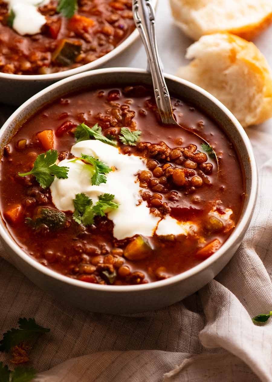 Bowl of Beef and Lentil Soup made with ground beef / beef mince topped with yogurt and fresh coriander/cilantro, ready to be eaten