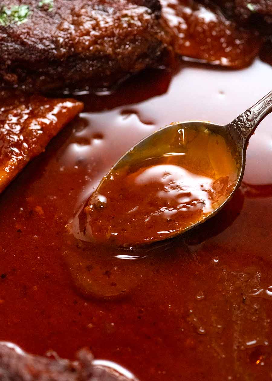 Spoon scooping up BBQ sauce for beef ribs