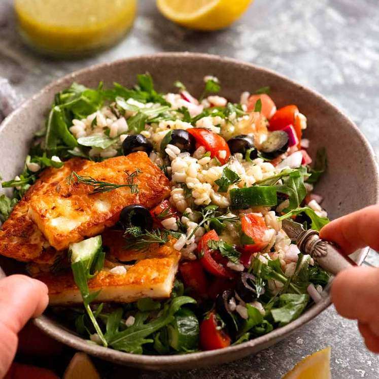 Bowl of Brown Rice Salad with halloumi, ready to be eaten