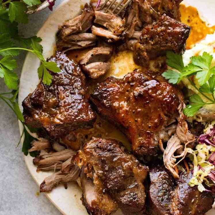 Overhead photo of Brown Sugar Garlic Butter Roast Pork on a plate with a side of cabbage salad