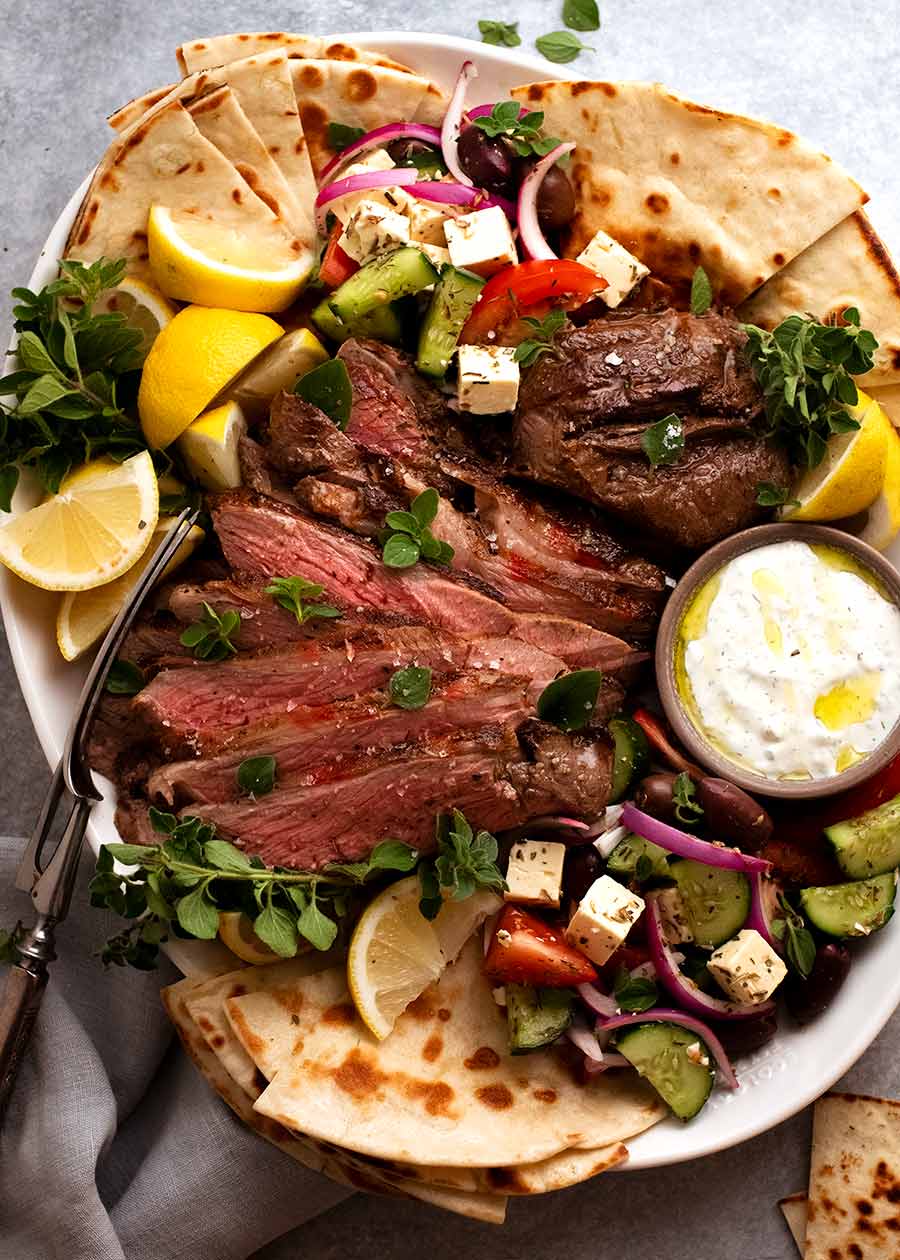 Greek Butterflied Lamb Leg on a platter, ready to be shared