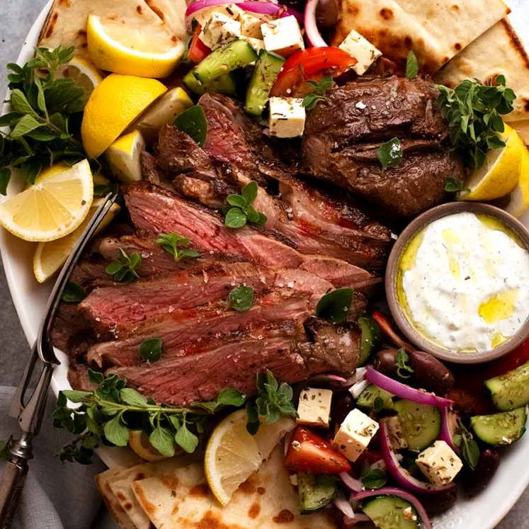 Greek Butterflied Lamb Leg on a platter, ready to be shared