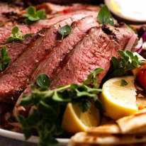 Close up photo of slices of Greek Butterflied Lamb Leg