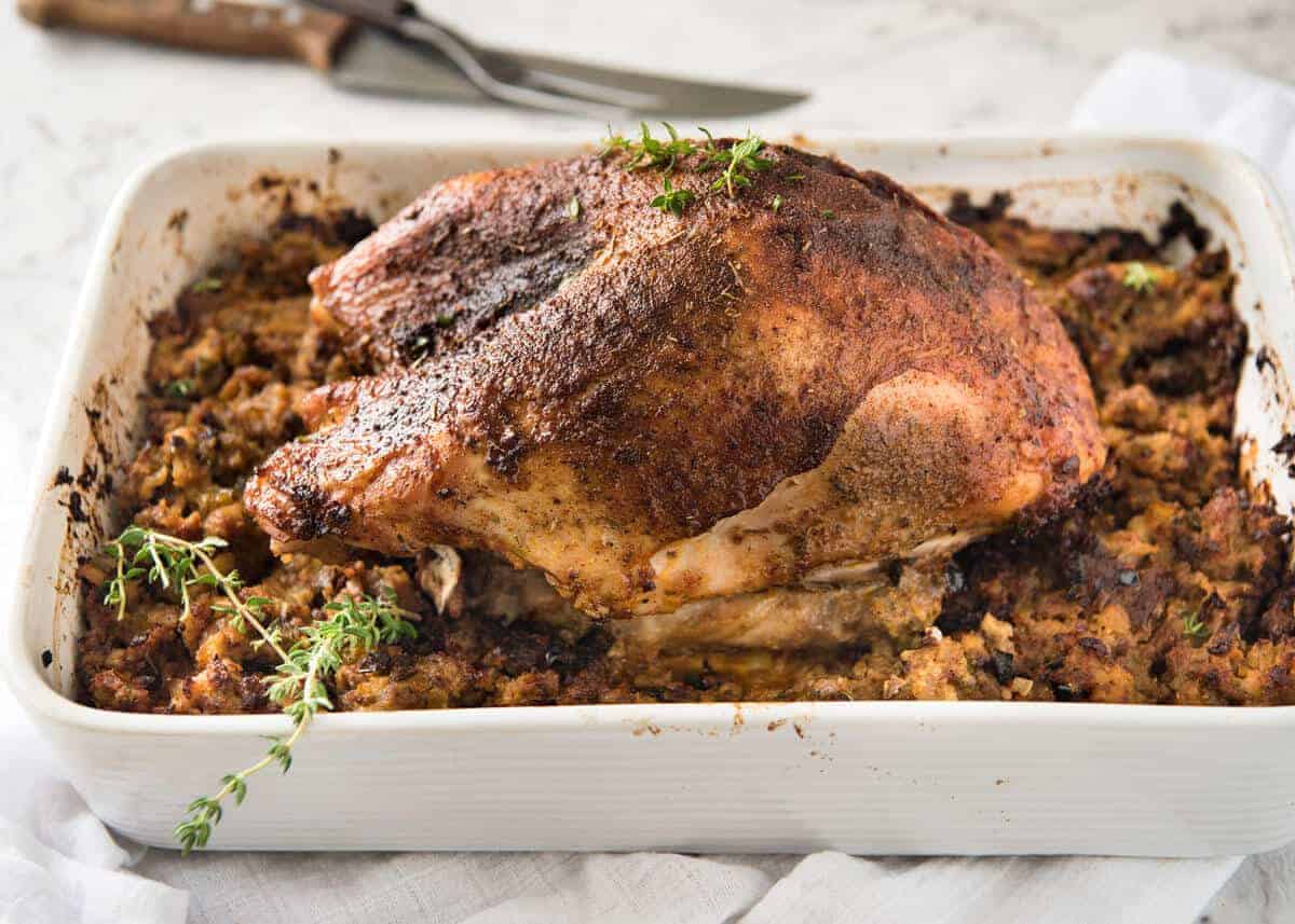 This Cajun dry brined turkey breast is baked in the same roasting pan as the Dressing / Stuffing so it's extra juicy and moist! A chef recipe, this Cajun Baked Turkey Breast with Dressing is easy and spectacular. EPIC ONE PAN COOKING for a Thanksgiving turkey! www.recipetineats.com