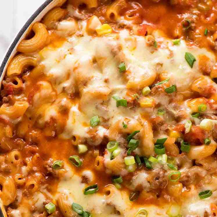 Overhead close up photo of Cheeseburger Casserole - homemade Hamburger Helper - fresh out of the oven in a white cast iron skillet