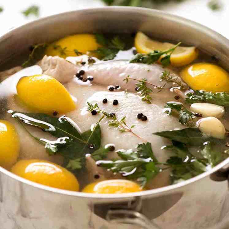 How to brine chicken - photo of whole raw chicken submerged in brine solution