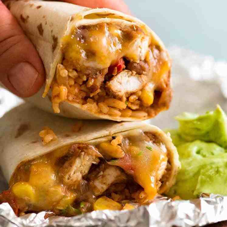 Hand picking up Chicken Burrito