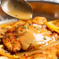 Chicken Francese sauce being poured over chicken