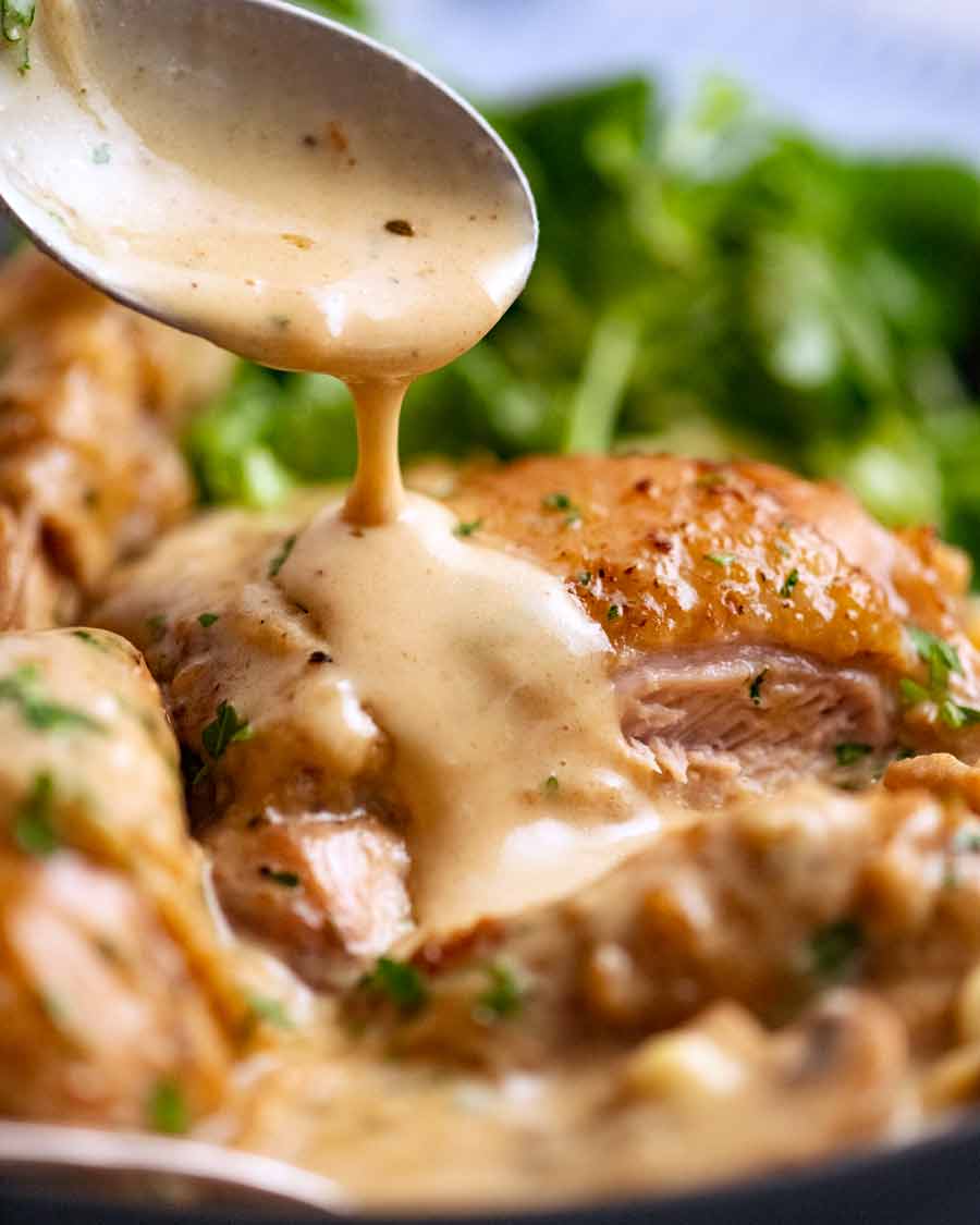 Drizzling Chicken Fricassée sauce over chicken