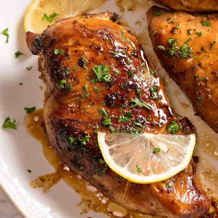 Cooked chicken breast (after marinated in Chicken Marinade) on a white plate, ready to be served