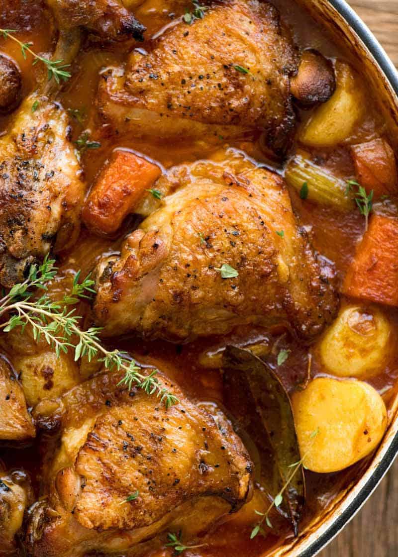 Overhead photo of Chicken Stew in a white dutch oven, fresh out of the oven.