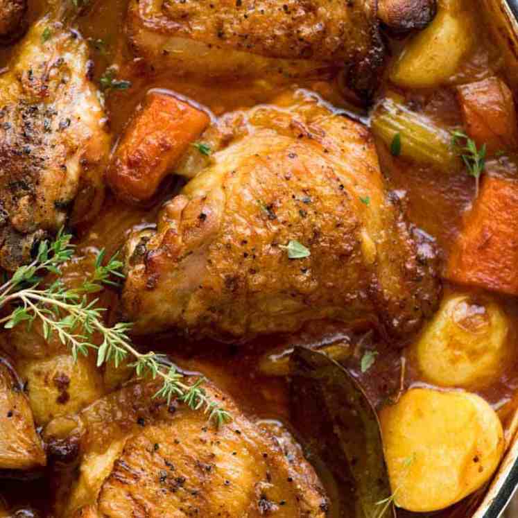 Overhead photo of Chicken Stew in a white dutch oven, fresh out of the oven.