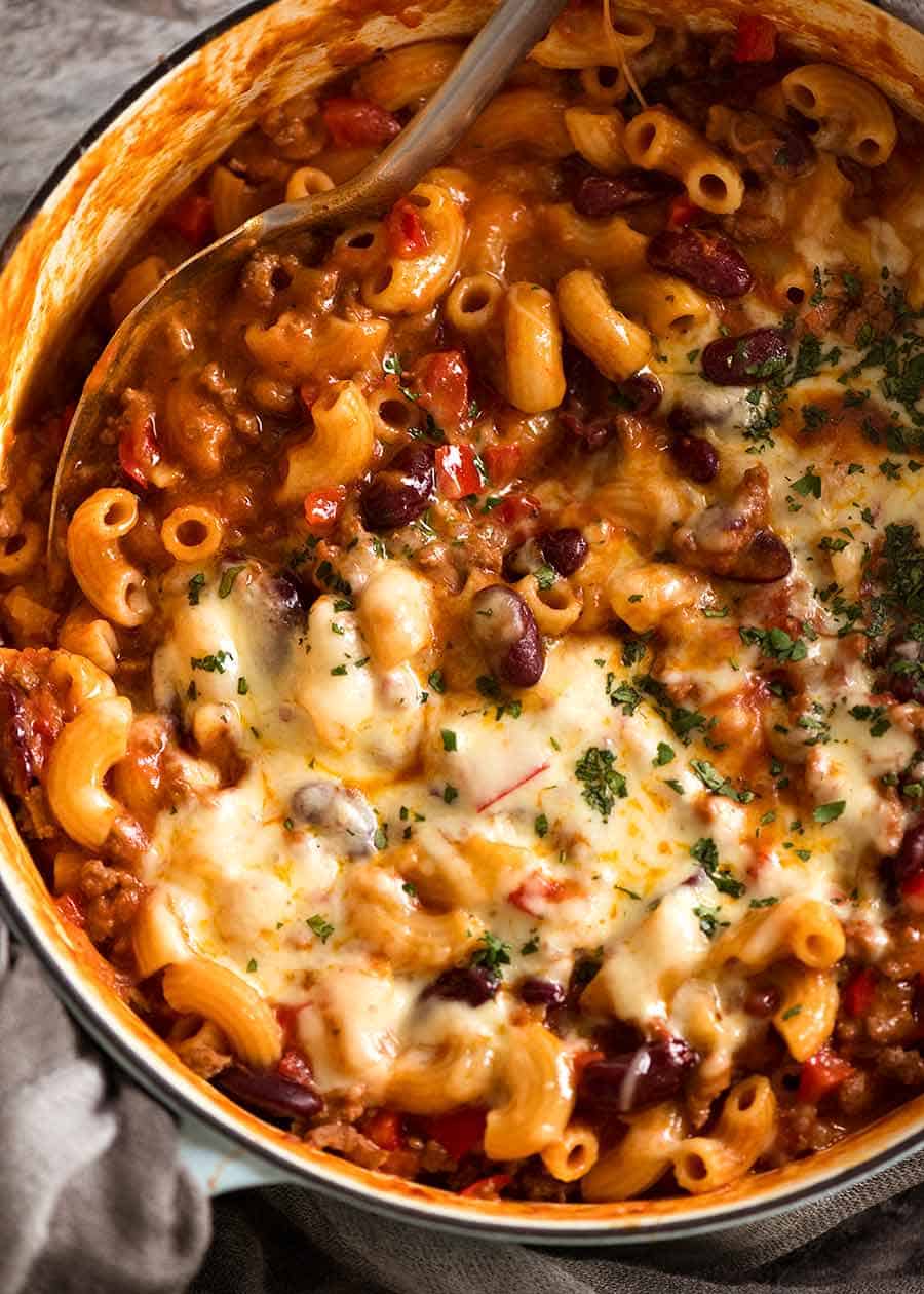 Chili Mac in a white cast iron pot, fresh off the stove ready to be served