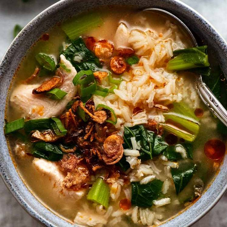 Overhead photo of Chinese Rice Soup in a blue bowl, ready to be eaten