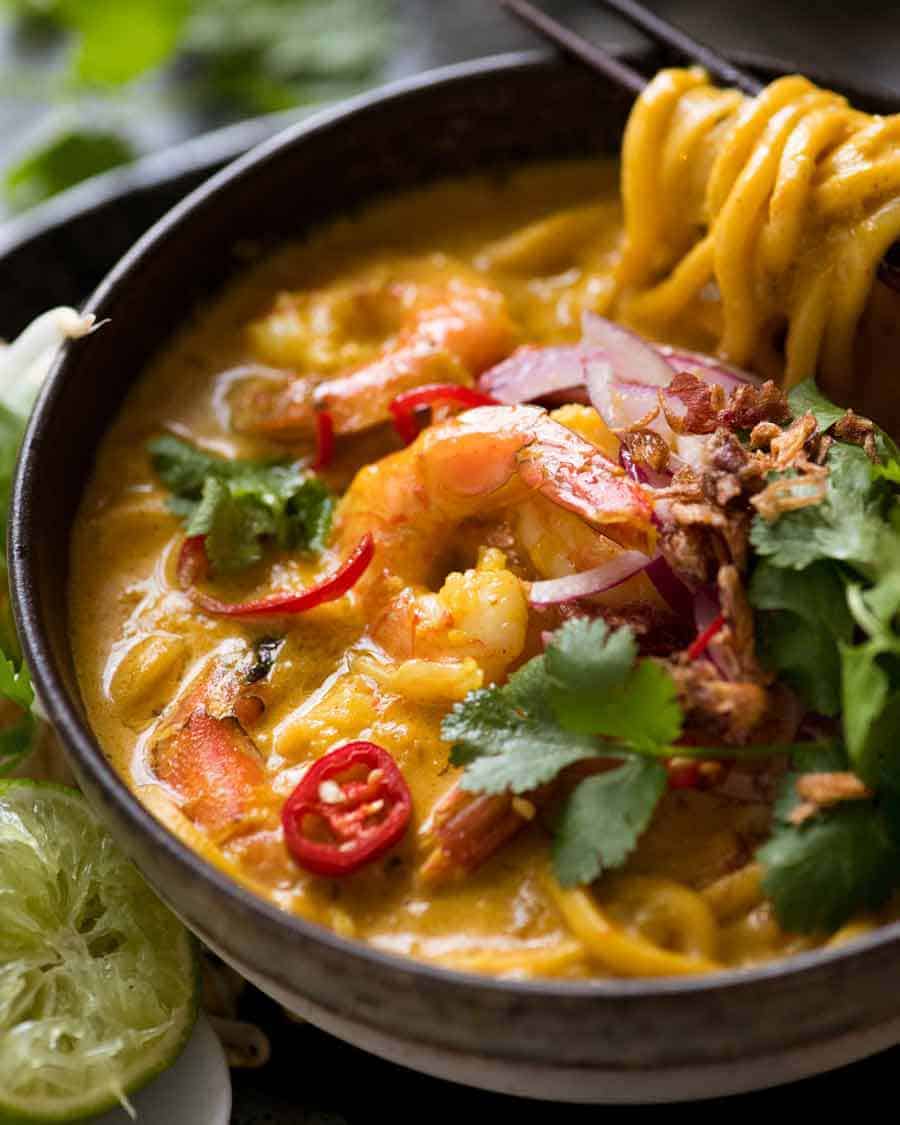 Thai Coconut Soup with Shrimp/Prawns and Noodles in a rustic bowl, ready to be eaten