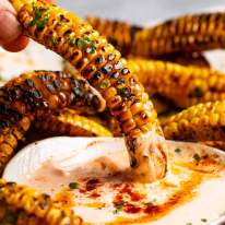 Dipping Corn ribs in sauce