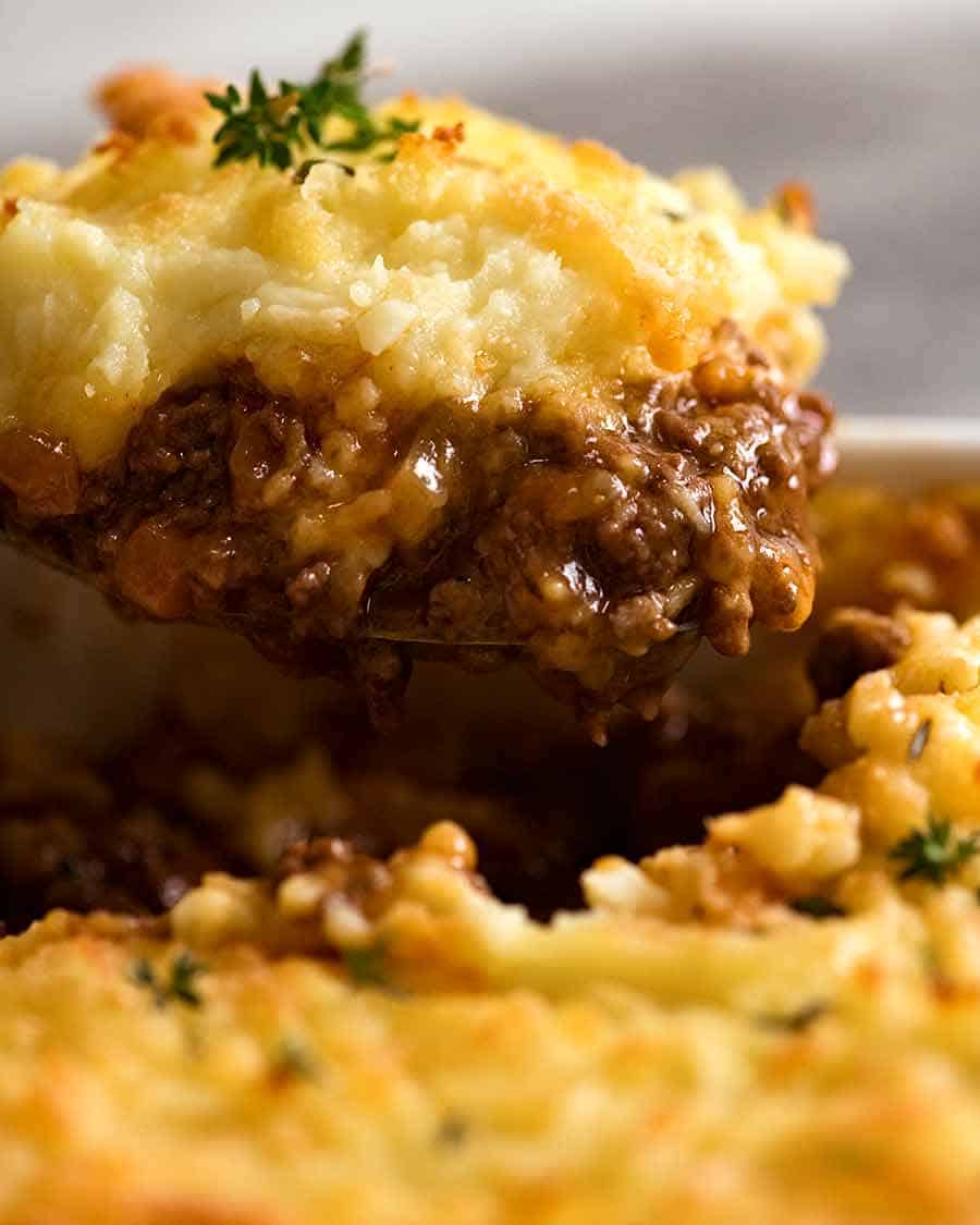 Close up of Cottage Pie being scooped out of baking dish, ready to be served