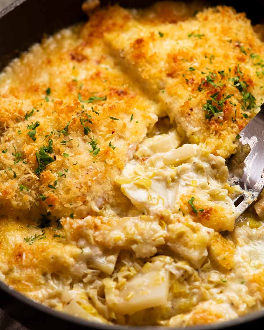 Scooping Creamy fish on potato gratin