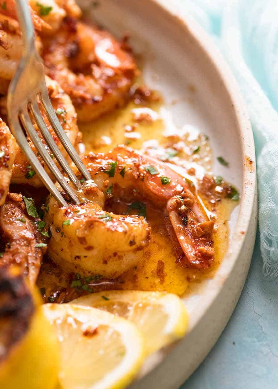 Close up of from piercing crispy prawns cooked on the BBQ with Lemon Garlic Butter Sauce