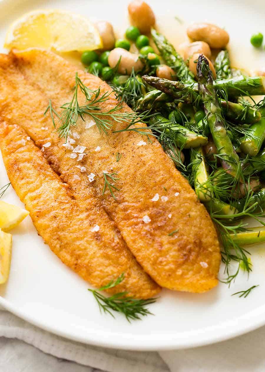 Overhead photo of Crispy Pan Fried Fish with a side of asparagus and beans