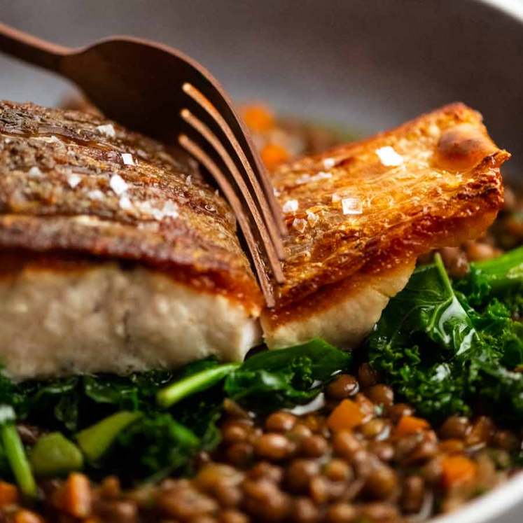 Fork cutting into Crispy Skin Barramundi