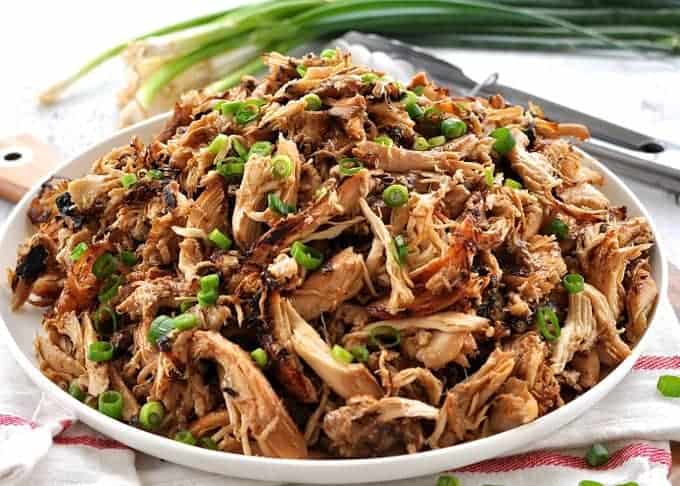 Pile of crispy Slow Cooker Chinese Shredded Chicken on a white plate