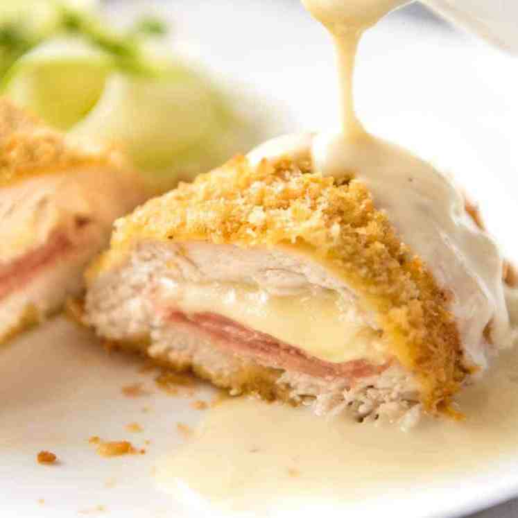 Close up of Dijon Cream Sauce being poured over Easy Chicken Cordon Bleu