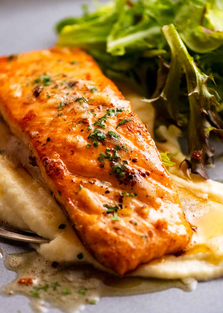 Garlic Butter Salmon on a plate with creamy cauliflower puree