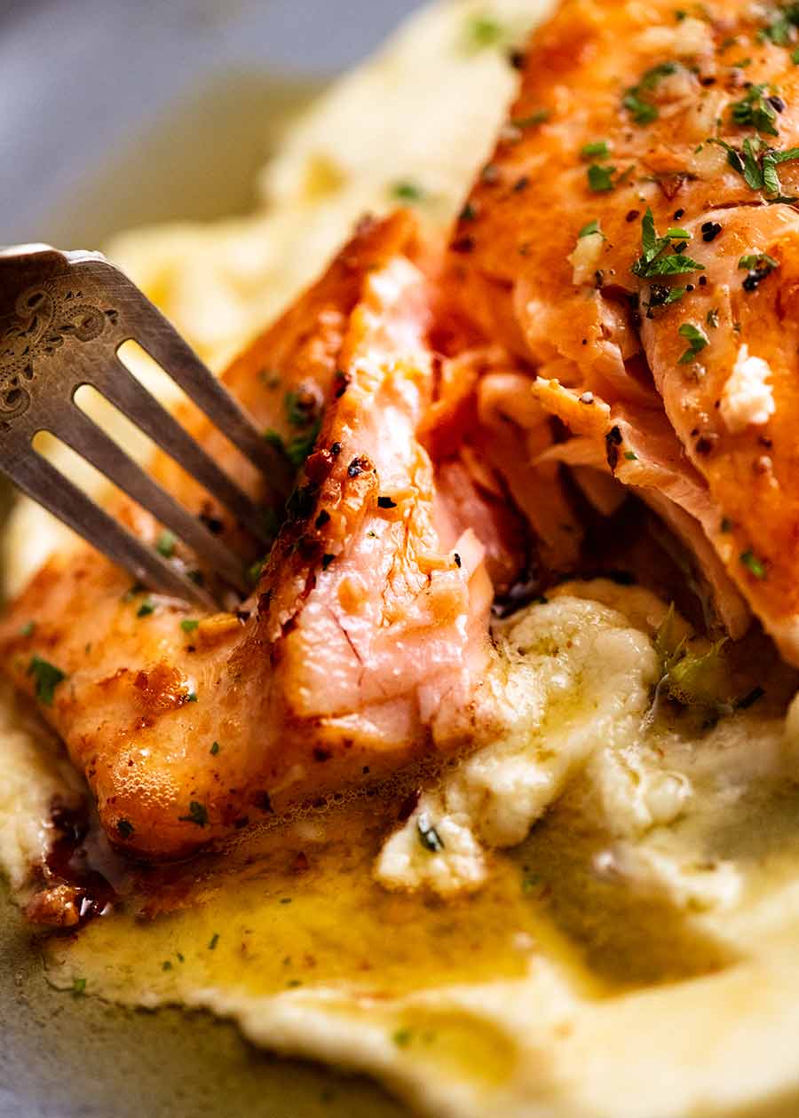 Fork cutting into Garlic Butter Salmon