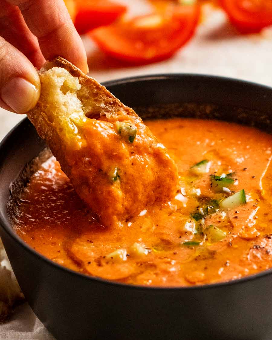 Dunking bread into Gazpacho