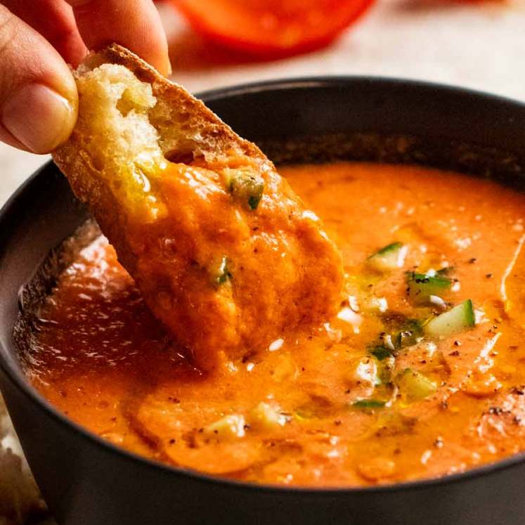 Dunking bread into Gazpacho