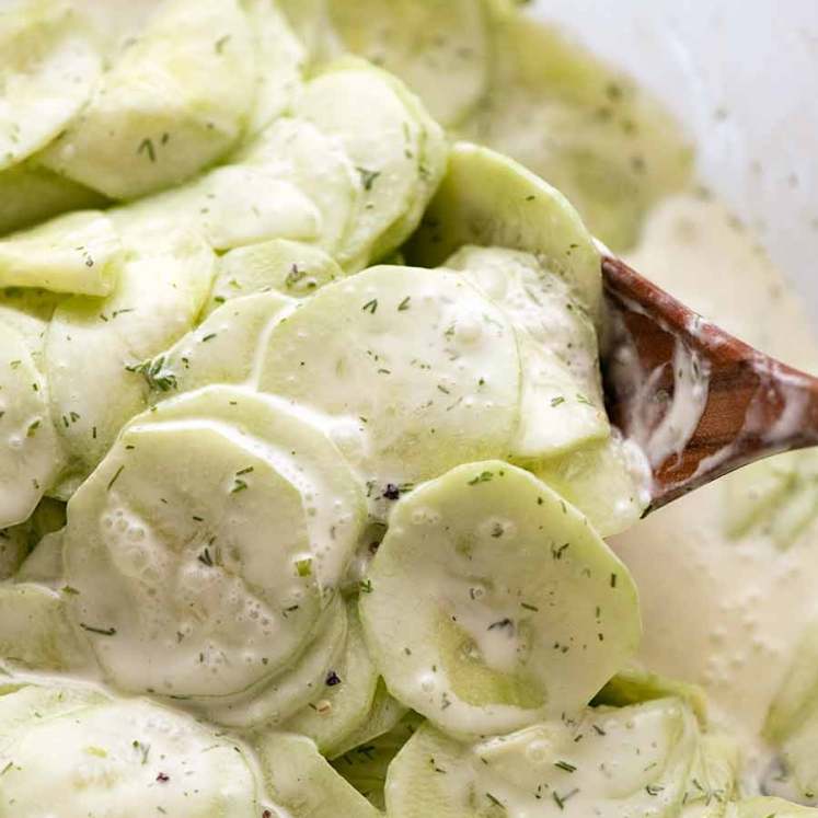 Mixing German Cucumber Salad in a bowl