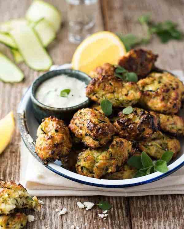 Greek Zucchini Tots / Fritters - transform the humble zucchini into these tasty bites! Easy to make, traditional Greek recipe. #courgette