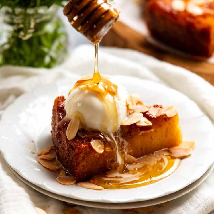 Slice of honey cake with vanilla ice cream