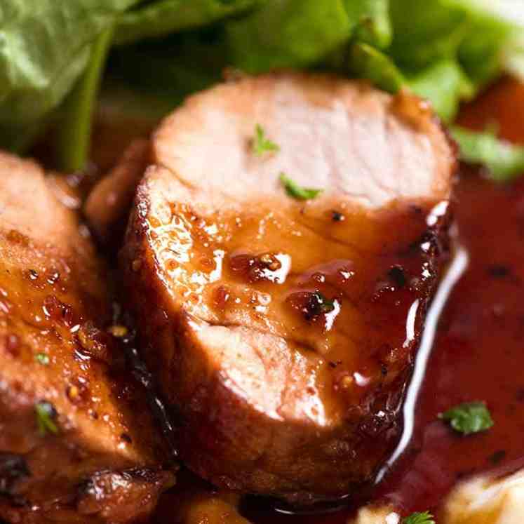 Slice of juicy Honey Garlic Pork Tenderloin on a bed of creamy mashed cauliflower