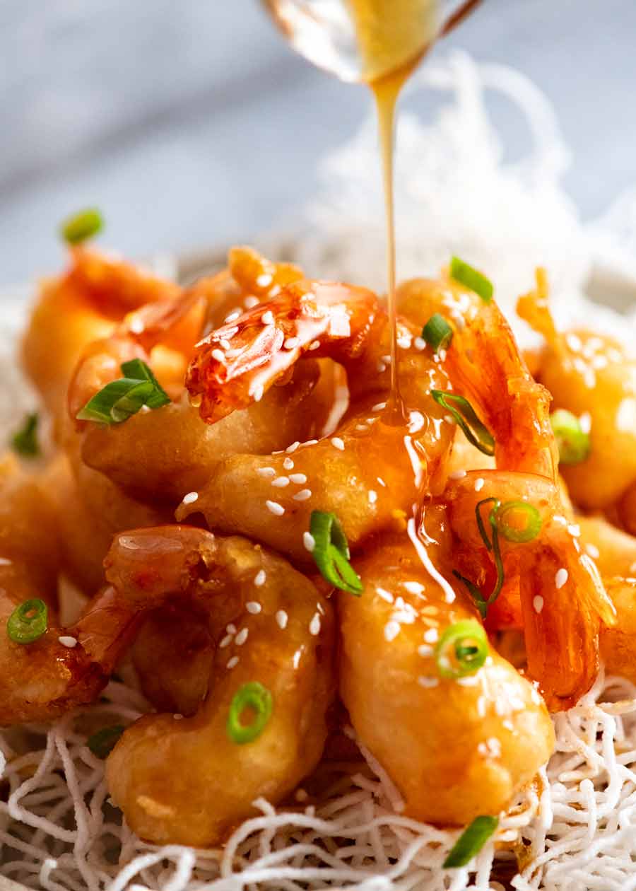 Pouring honey sauce over Honey Prawns