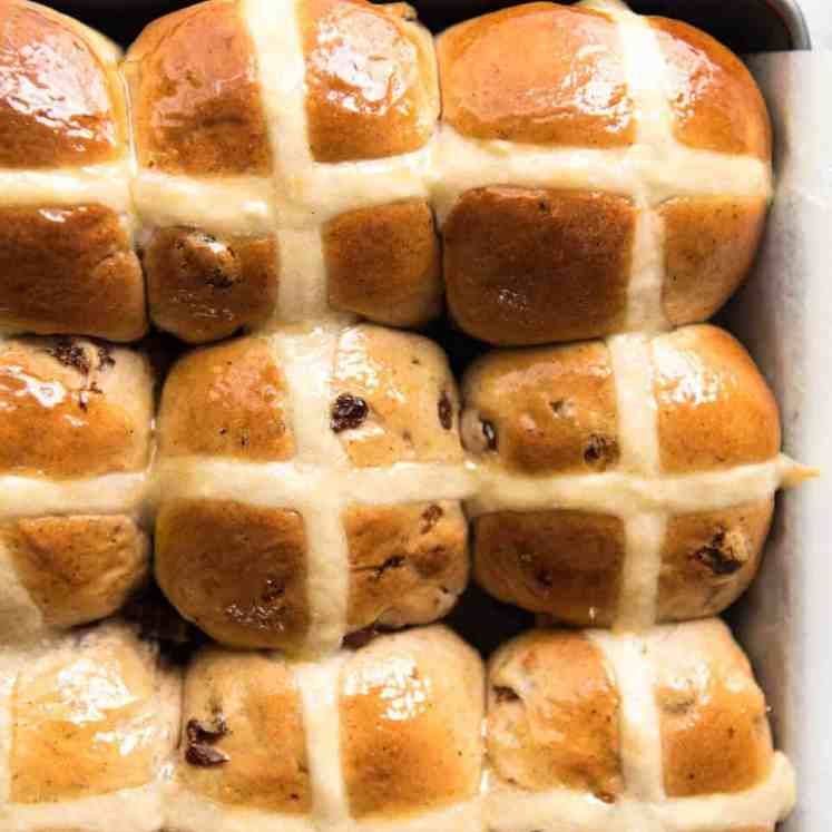 9 Homemade Hot Cross Buns photographed from overhead in a silver tray.