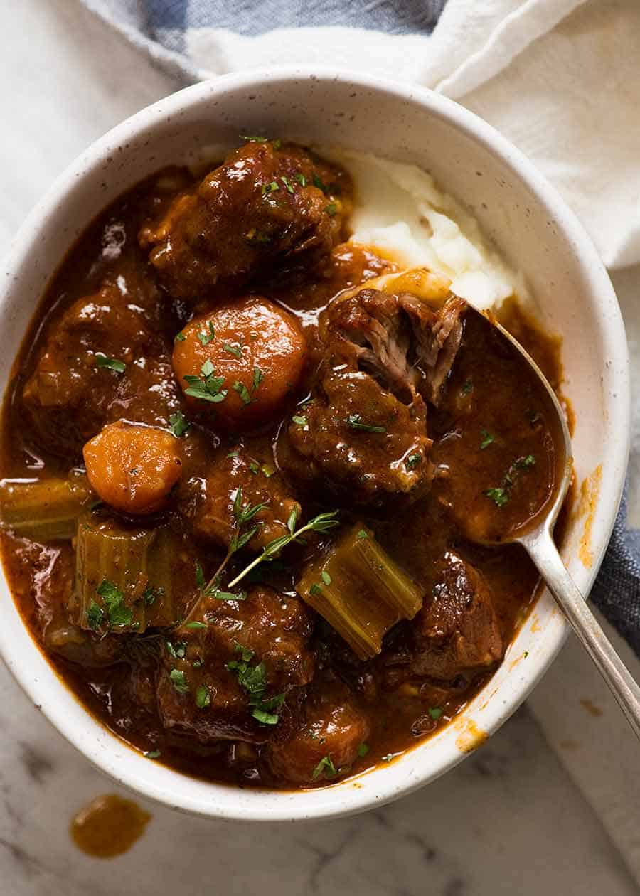 Overhead photo of Irish Beef Guinness Stew over mashed potato, ready to be eaten