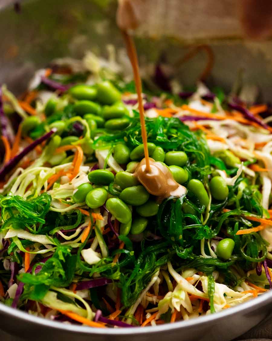 Pouring dressing over Japanese Slaw - Chargrill Charlie's Copycat