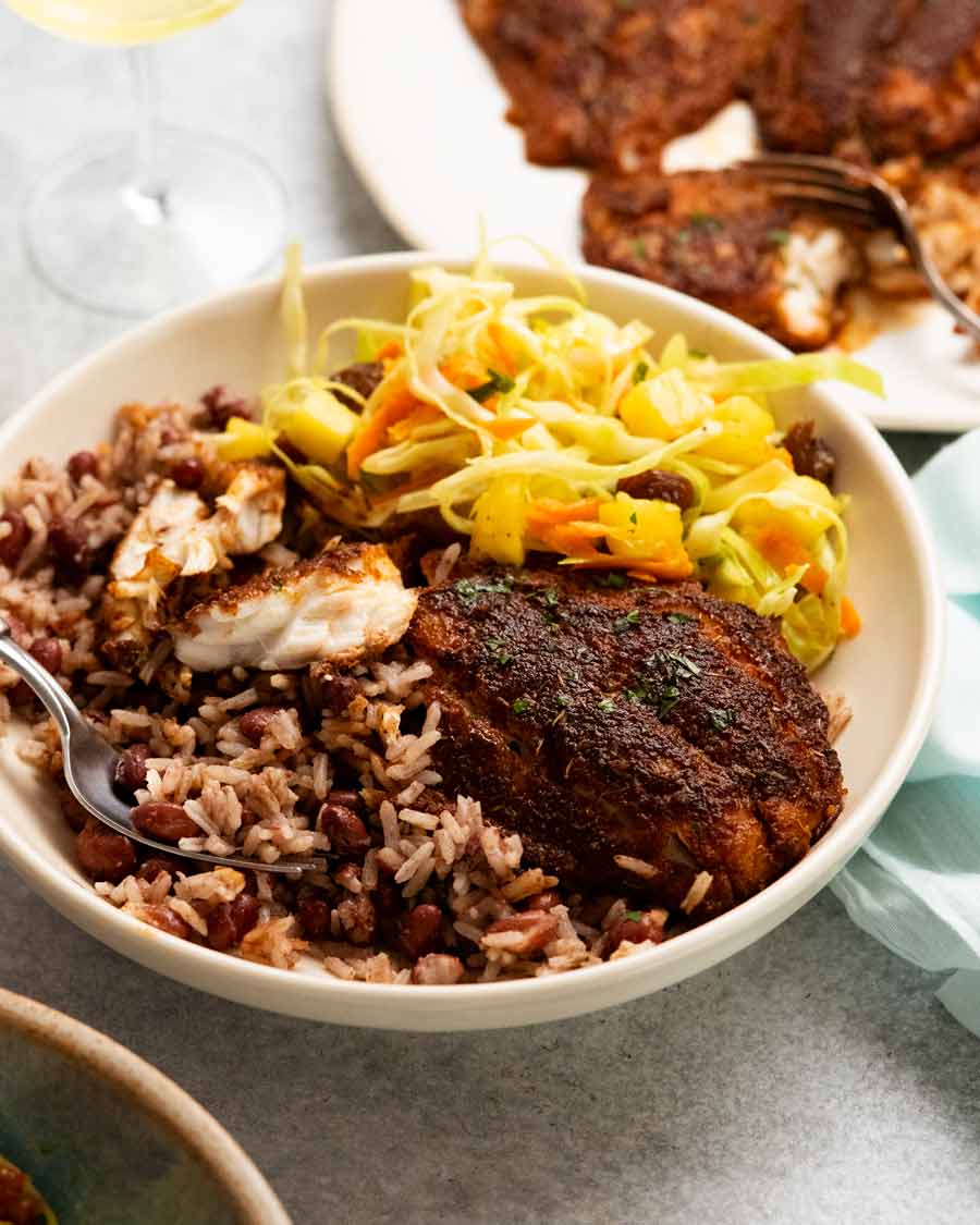 Jamaican Jerk Fish on a plate with Jamaican Slaw and Coconut Rice & Beans