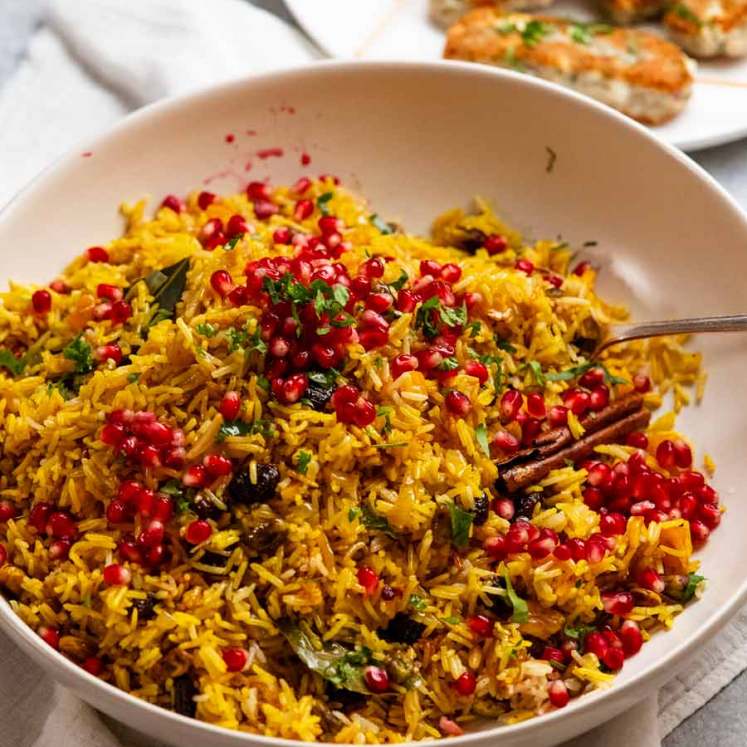 Platter of jewelled rice with fish koftas on the side