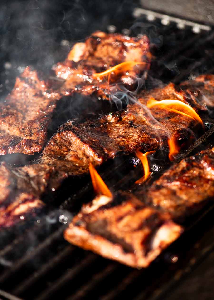 Korean BBQ Marinated Beef Short ribs (Galbi) cooking on a BBQ grill