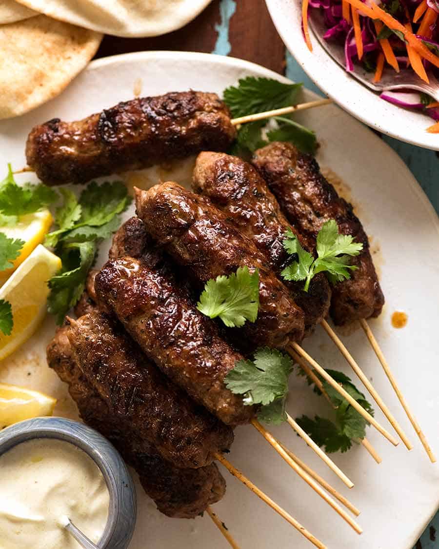 Lamb Koftas on a platter, ready to stuff into pita bread with minted salad and yogurt sauce