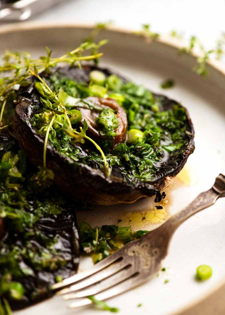 Roasted Large Mushrooms with Green Onion Thyme Butter on a plate, ready to be eaten